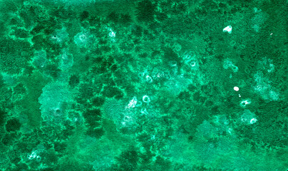 Green background with beautiful watercolor stains.
  Abstract emerald background. Watercolor texture. Imitation of water, drops, splashes of paint.