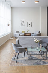 minimalist modern interior design huge bright apartment with an open plan in Scandinavian style in white, blue and dark blue colors with columns in the center. includes kitchen area, office and lounge