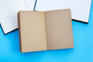 Notebooks on blue background. Top view