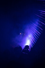 Obraz na płótnie Canvas DJ's playing under lights at a night festival.