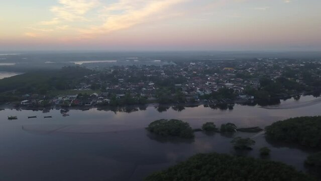 Beautiful drone aerial view of Paranagua city skyline, river, mangrove and sea at sunset. Concept of travel, nature, tourism, cityscape. Parana, Brazil.