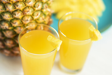pineapple juice in a glass on a white background, fruity summer refreshing cocktail
