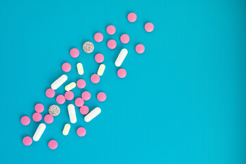 drug delivery, different pills on a blue background