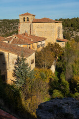 Fototapeta premium Aerial view of the traditional houses of the medieval village of Calatañazor and the church in a sunny day, Soria in autumn, Castilla y Leon, Spain.