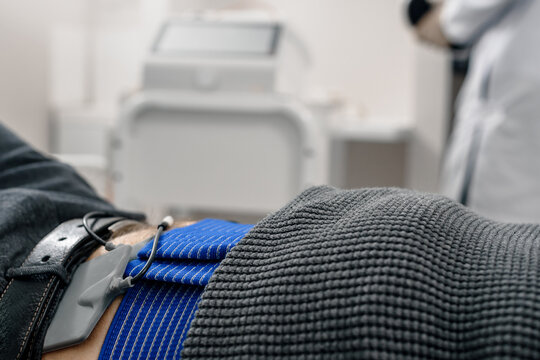 Male Patient Having Spinal Traction Procedure In Medical Clinic