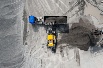 Limestone mining in open quarry, Industrial excavator dump stone loading on truck