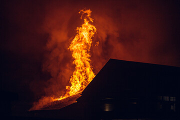 House on fire at night. Strong fire in a small village