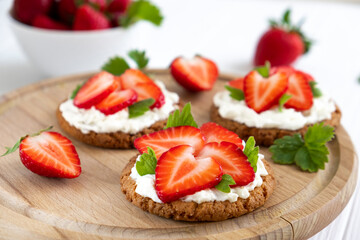 Homemade healthy crispbread bruschetta with strawberry and cream cheese. Healthy snack, keto diet...