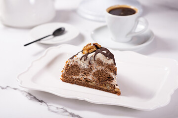 Cake Count's ruins on a white table. Cake with chocolate and walnuts.