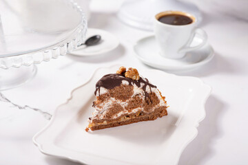 Cake Count's ruins on a white table. Cake with chocolate and walnuts.
