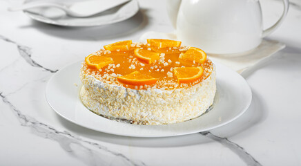 Orange cake on light marble table
