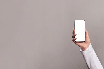 Doctor hand demonstrating smartphone with blank screen for advertisement