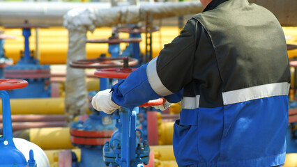 Gas industry, gas transmission system and gas pipeline. Communications, a worker opens and closes...