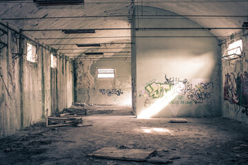 View of an abandoned building with graffitis on the walls