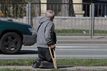 person walking with a cane, 

a man is crippled without feet