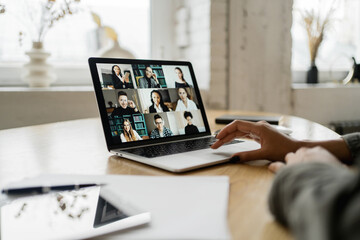 Online video communication with colleagues laptop screen in the office