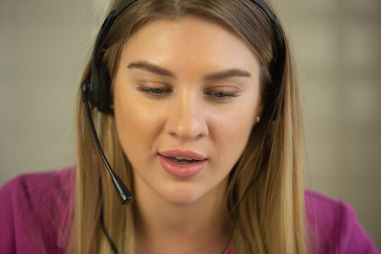 Friendly online support operator talking to client. Young Ukrainian woman working online as call center specialist