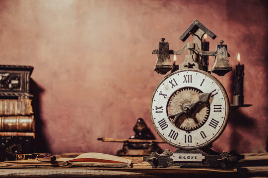 Vintage wallpaper with copy space. Antique desk with clock, inkwell and pen.