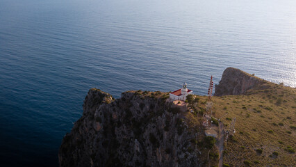 Lighthouse of Capo Palinuro at sunset with a view of the deep blue sea, Cilento, Campania, Italy.