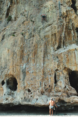 Vertical shot of a free climber in action while climbing a rocky wall  Cilento, Campania, Italy