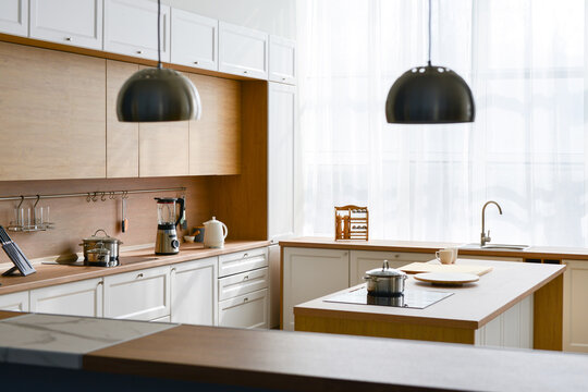 Modern New Light Interior Of Kitchen With White Furniture And Table