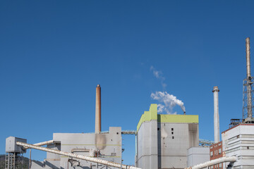 Factory Smokestack Against Blue Sky