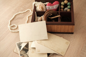 dear to heart memorabilia in an old wooden box, lock of hair, stack of retro photos, vintage...