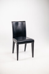 modern leather black chair with a back on a white isolated background. Furniture for home and office