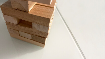Jenga tower made of wooden blocks on a gray background, a board game for family games, children's development, logical you can build anything from wooden blocks,family fun at the table