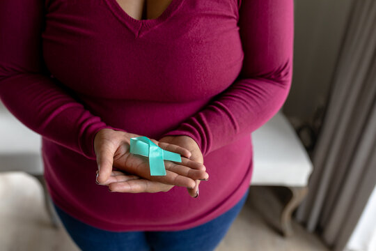 Midsection Of African American Mid Adult Woman Showing Prostate Cancer Awareness Blue Ribbon