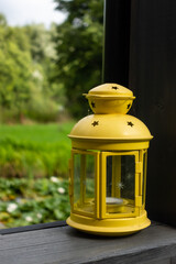 Yellow garden lantern on the balustrade of the garden terrace. Photo taken on a sunny day with good...