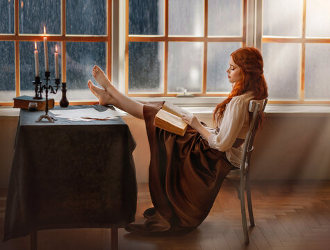 red-haired medieval woman sits on chair, legs lie on table, brutal pose. Girl fashion model in vintage elegant dress reading historical detective book. Romantic lady countess in night library old room
