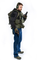 soldier, airsoft player in full gear with a gun. a man in headphones, body armor, with a backpack and a belt. White background.