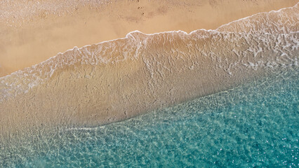 Fototapeta na wymiar Aerial view of beautiful sandy beach and soft turquoise ocean wave. Tropical sea in summer season on Egremni beach on Lefkada island.