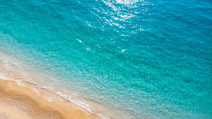 Aerial view of beautiful sandy beach and soft turquoise ocean wave. Tropical sea in summer season on Porto Katsiki beach on Lefkada island.