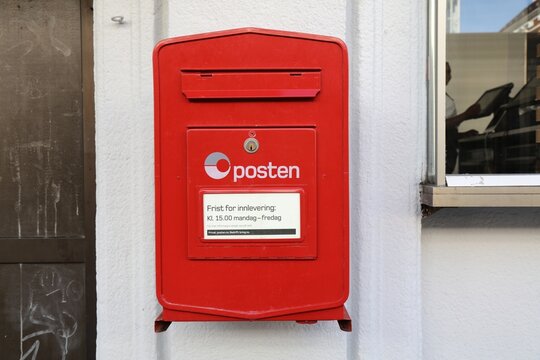 BERGEN, NORWAY - JULY 23, 2020: Red post box of Posten Norge (The Norwegian Post) in Bergen. Posten was founded in 1647.