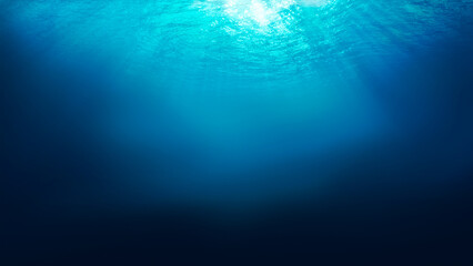 Sunlight shining through the surface of the blue ocean, sea, with dark waters below.