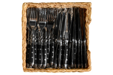 Cutlery in a beautiful wicker basket on an isolated white background