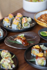 Nigiri Sushi Style served on a wooden table along with sushi