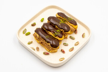 Chocolate eclair cake. Pistachio and chocolate eclair cake on a white background. close up