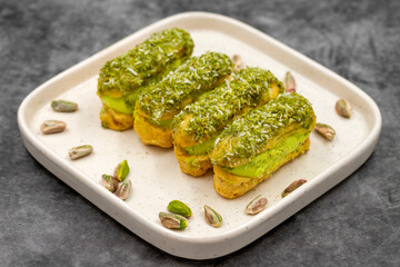 Pistachio eclair cake. Eclair cake with pistachio filling on a dark background. close up