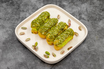 Pistachio eclair cake. Eclair cake with pistachio filling on a dark background. close up