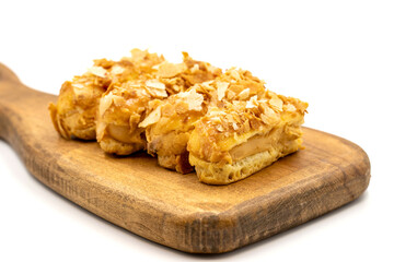 Cream eclairs cake. Eclair cake with cream filling on a white background. close up