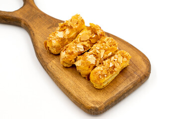 Cream eclairs cake. Eclair cake with cream filling on a white background. close up