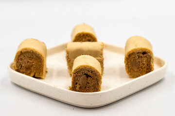 Roll cake with hazelnut and chocolate filling. roll cake on a white background. close up