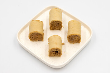 Roll cake with hazelnut and chocolate filling. roll cake on a white background. close up