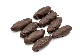 Special chocolate with dark outside and coconut inside. Dark chocolate with coconut filling on a white background. close up