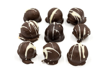 Special chocolate with dark outside and coconut inside. Dark chocolate with coconut filling on a white background. close up