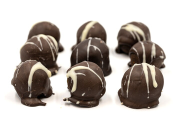 Special chocolate with dark outside and coconut inside. Dark chocolate with coconut filling on a white background. close up