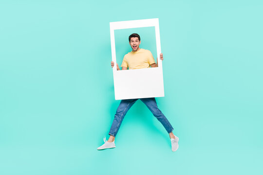 Full body portrait of crazy energetic person hold paper album card isolated on teal color background